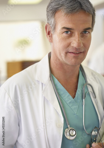 Photo: Male doctor with clipboard and stethoscope in hospital Male doctor with clipboard and stethoscope in hospital