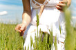 Woman looking at ladybug on rye