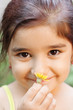 Girl smelling flower