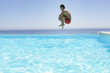 Man leaping into infinity pool