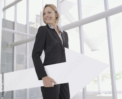 Photo: Businesswoman with blank sign arrow Businesswoman with blank sign arrow