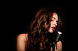 Beautiful singer singing with microphone