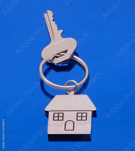 Photo: chrome house key on blue background chrome house key on blue background