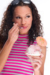 young femail eating ice cream decorated with orange umbrela