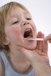 Female doctor is looking to the glands of a little boy