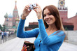 Woman tourist are photographed in Moscow (Russia)