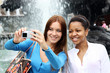 Two girls tourists are photographed in Moscow (Russia)