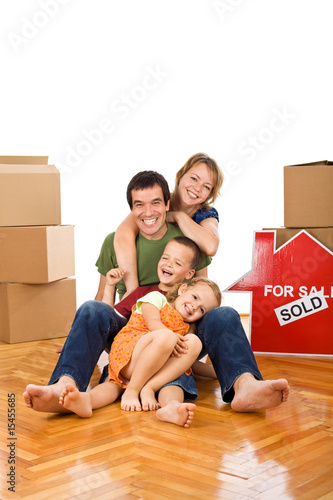 Photo: Happy couple with two kids in their new home Happy couple with two kids in their new home