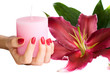 Hand with manicure holding a candle