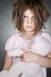 Messy Upset Child Gripping her Teddy Bear