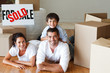 Happy parents and son lying on the floor after buying house