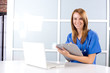 Female nurse at a desk working in a modern office