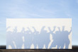 Silhouette shadows of people on a billboard