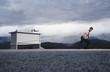 Man attempting to pull his desk outdoors with a long rope