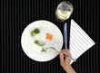 Plate with vegetables on a table with a textured towel.