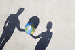 Aerial View of two shadows holding globe outdoors
