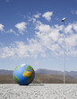 Globe on gravel with surveillance camera outdoors