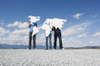 Three people holding continents