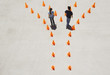 Foto: Man and woman in traffic cones moving apart Man and woman in traffic cones moving apart