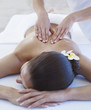 Masseuse giving a woman a back massage