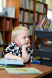 Thinking boy in the library