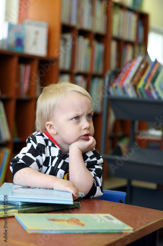 Photo: Thinking boy in the library Thinking boy in the library