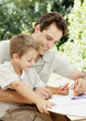 A father and son colouring together