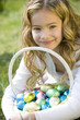 Portrait of Young Girl Holding Basket Full of Easter Eggs