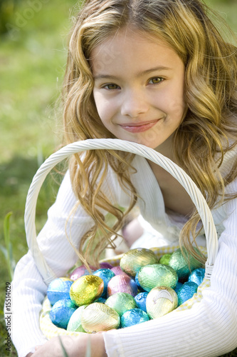 Photo: Portrait of Young Girl Holding Basket Full of Easter Eggs Portrait of Young Girl Holding Basket Full of Easter Eggs