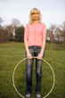 Young Woman Standing With Hula Hoop Smiling