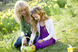 Mother and Daughter Looking at Basket Of Easter Eggs