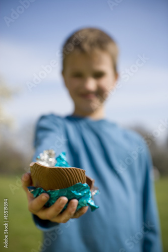 Photo: Young Boy Holding Chocolate Easter Egg Young Boy Holding Chocolate Easter Egg