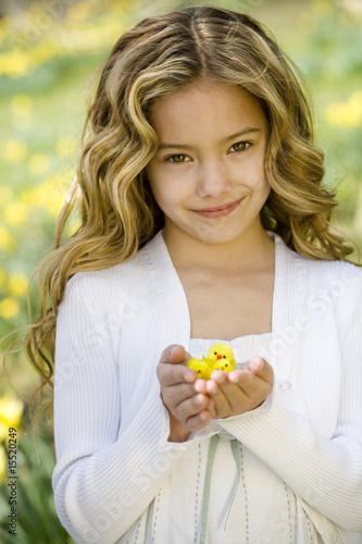 Photo: Young Girl Holding Easter Chicks Toys Young Girl Holding Easter Chicks Toys
