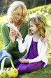 Mother and Daughter Looking at Toy Easter Bunny