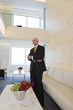 Photo: View of senior executive standing in lobby. View of senior executive standing in lobby.
