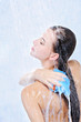 woman washing her body in a shower