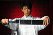 Young Asian Man Unsheading A Sword