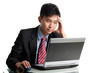 Photo: Troubled Asian businessman having a bad day and headache Troubled Asian businessman having a bad day and headache