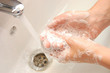 woman washing hand under running water woman washing hand under running water