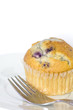 blueberry muffin on plate with fork