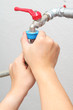 Tightening piping connections, with slight water leakage shown