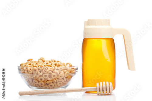 Photo: Honey pitcher and bowl of cheerios Honey pitcher and bowl of cheerios