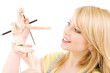 happy teenage girl with wooden model dummy