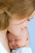 Beautiful baby of three months old in his mothers hands.
