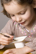 Little girl eating yogurt