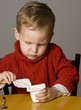 Little Boy opening a yogurt