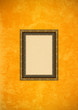 Grunge orange stucco wall with empty picture frame