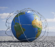 A globe entangled in barbed wire