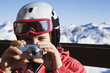 A girl taking a picture outdoors in the snow