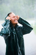 Young woman enjoying in rain